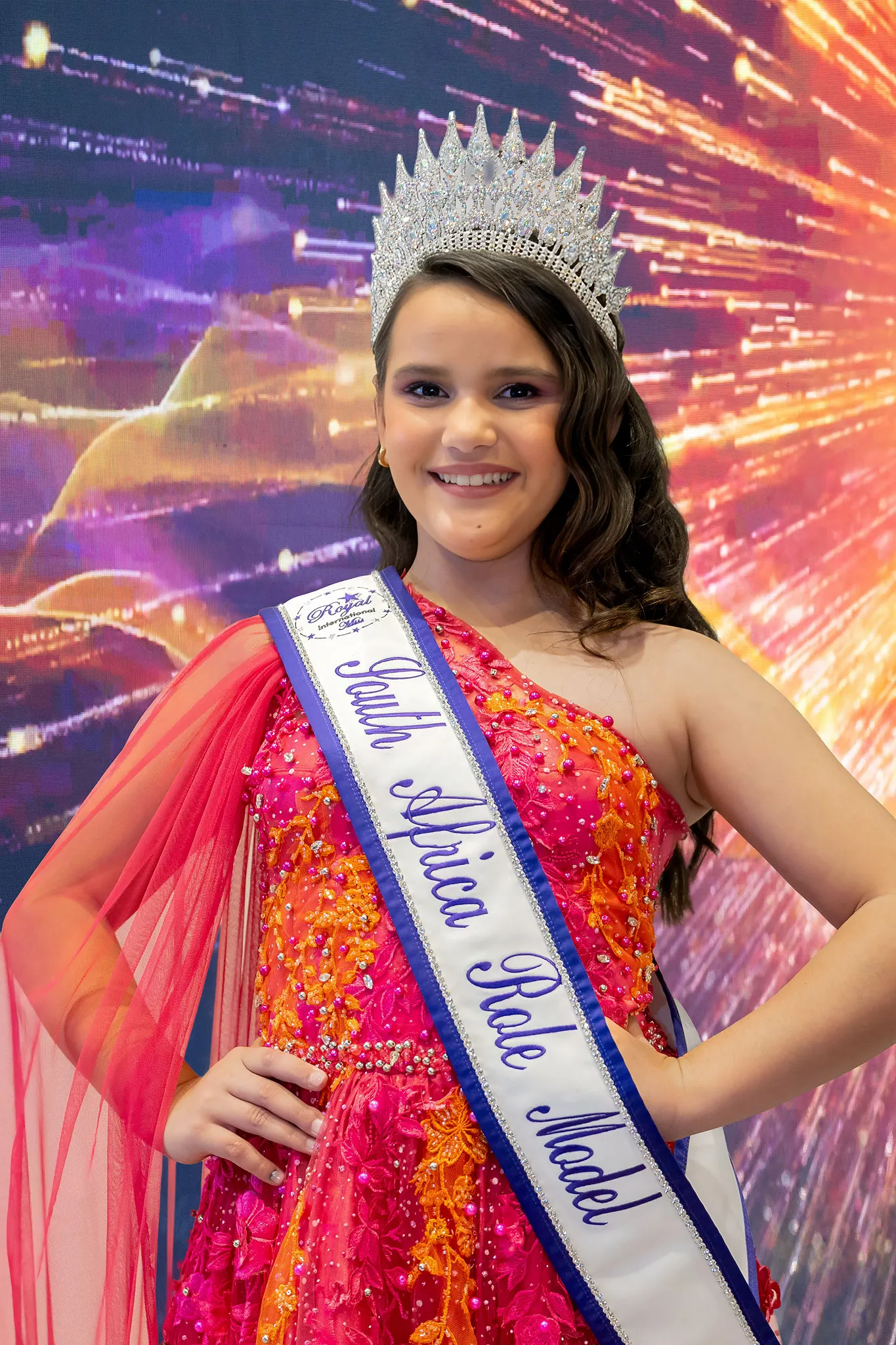 Anastasia Rodakis crowned Pre-Teen Role Model, in a fuchsia and orange sequinned gown with a sheer cape