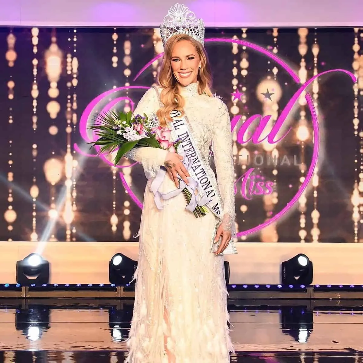 Bianca Andrews crowned on the Royal International Miss stage in Orlando, in an ivory lace gown