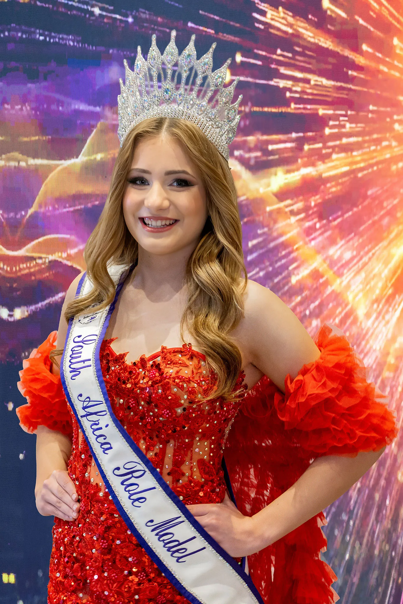 Délyn van Rooyen crowned Teen Role Model, in a red sequinned gown with ruffled sleeves