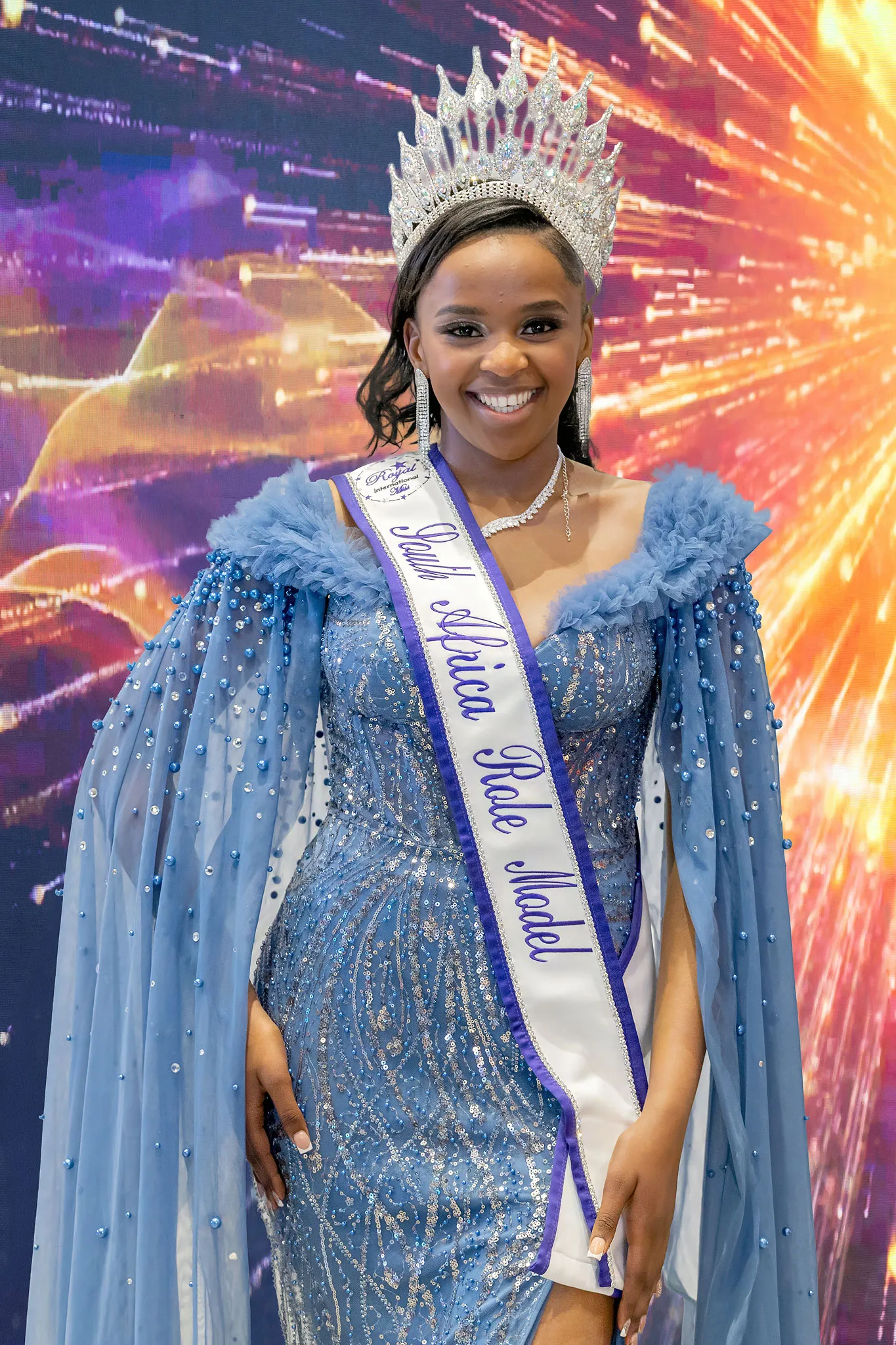 Lisakhanya Masika crowned Miss Role Model, in a blue beaded gown with a sheer cape