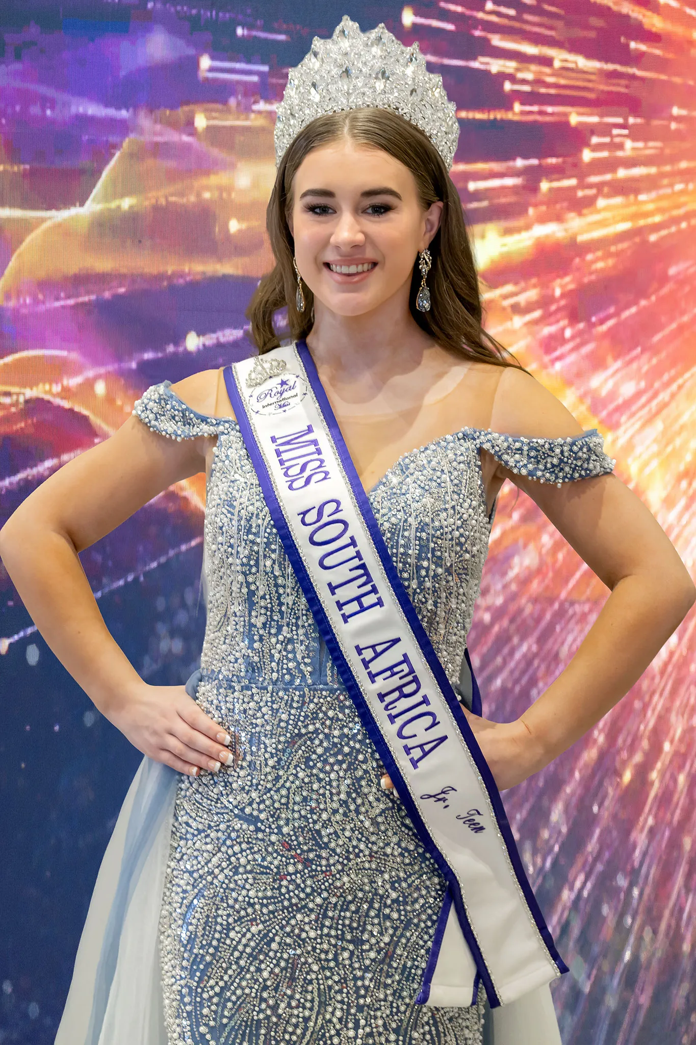 Nicola Benadie crowned Junior Teen, in an off-the-shoulder silver rhinestone gown